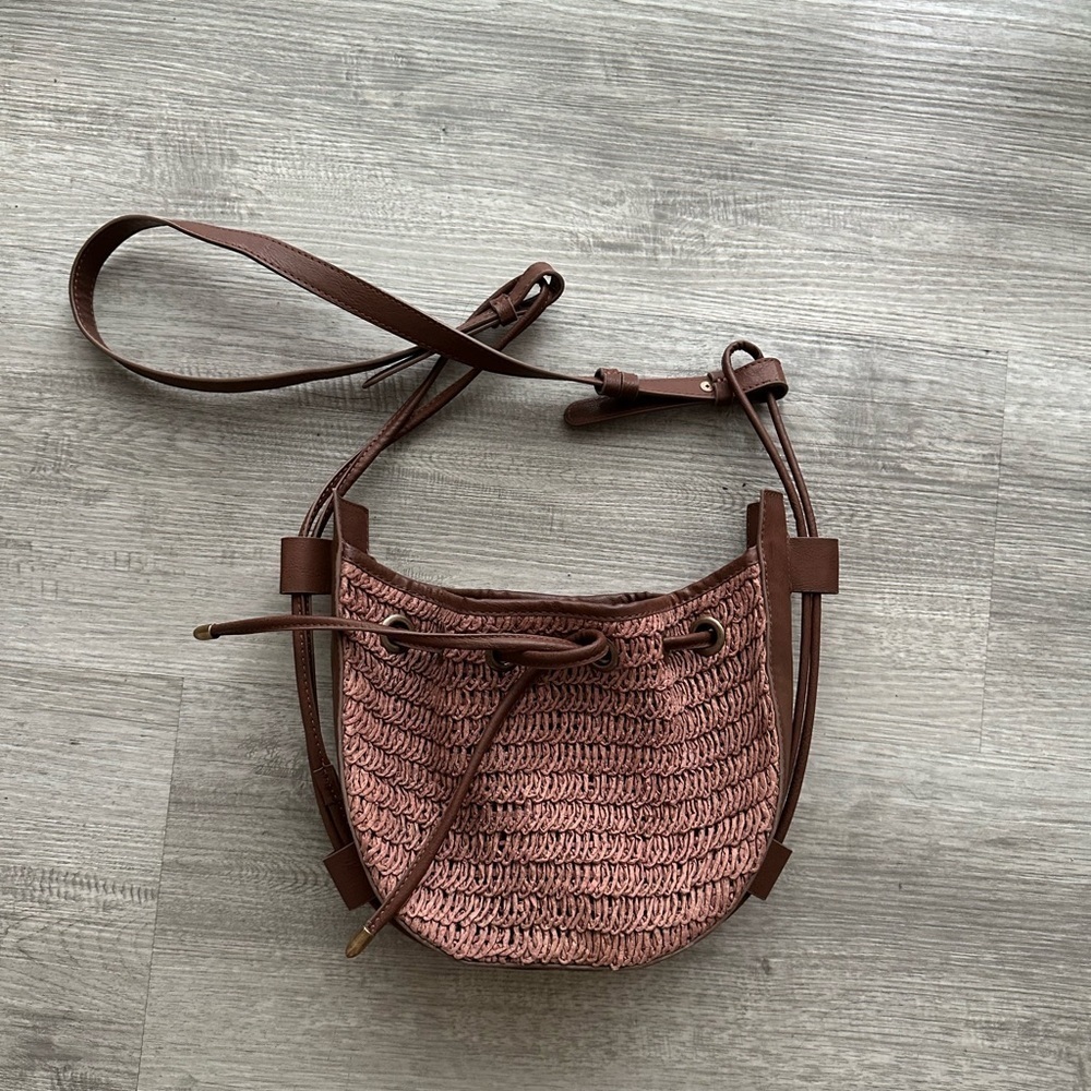 FREE PEOPLE VINTAGE 
CABANA WOVEN DRAWSTRING VEGAN
LEATHER CROSSBODY BAG
